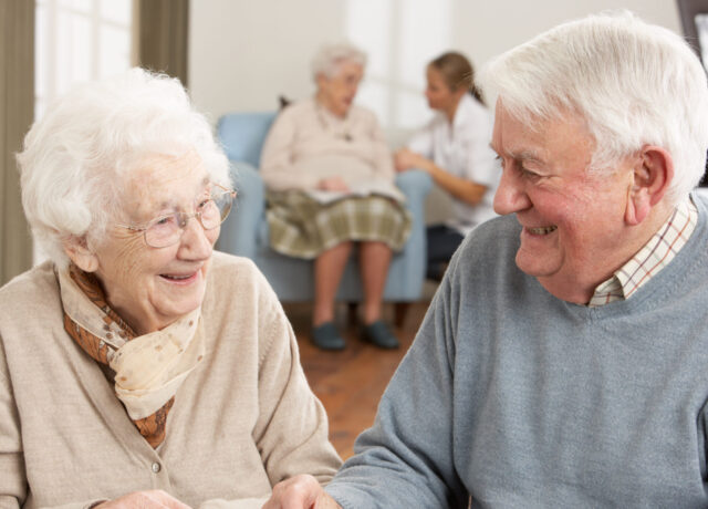 An older man and woman laughing together